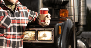 Trucker Holding Coffee wearing Autumn Clothes